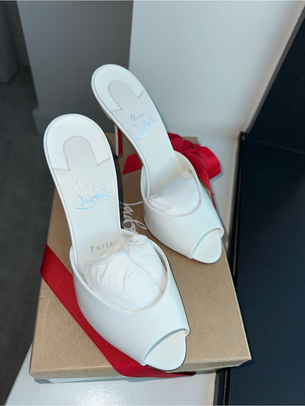 Christian Louboutin -
Me Dolly 
White Patent Open-Toe Mule Heels